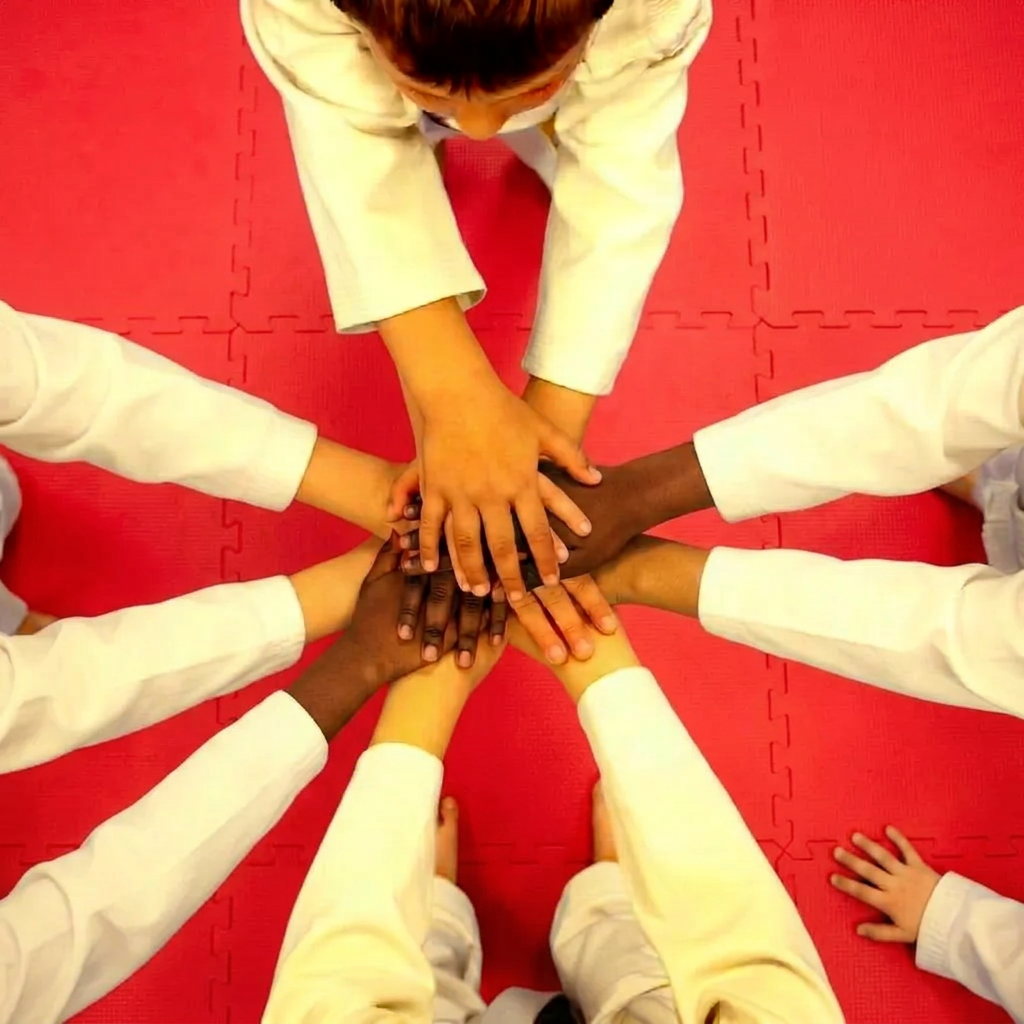 Bird's-eye view of party guests stacking hands in a circle on the mat